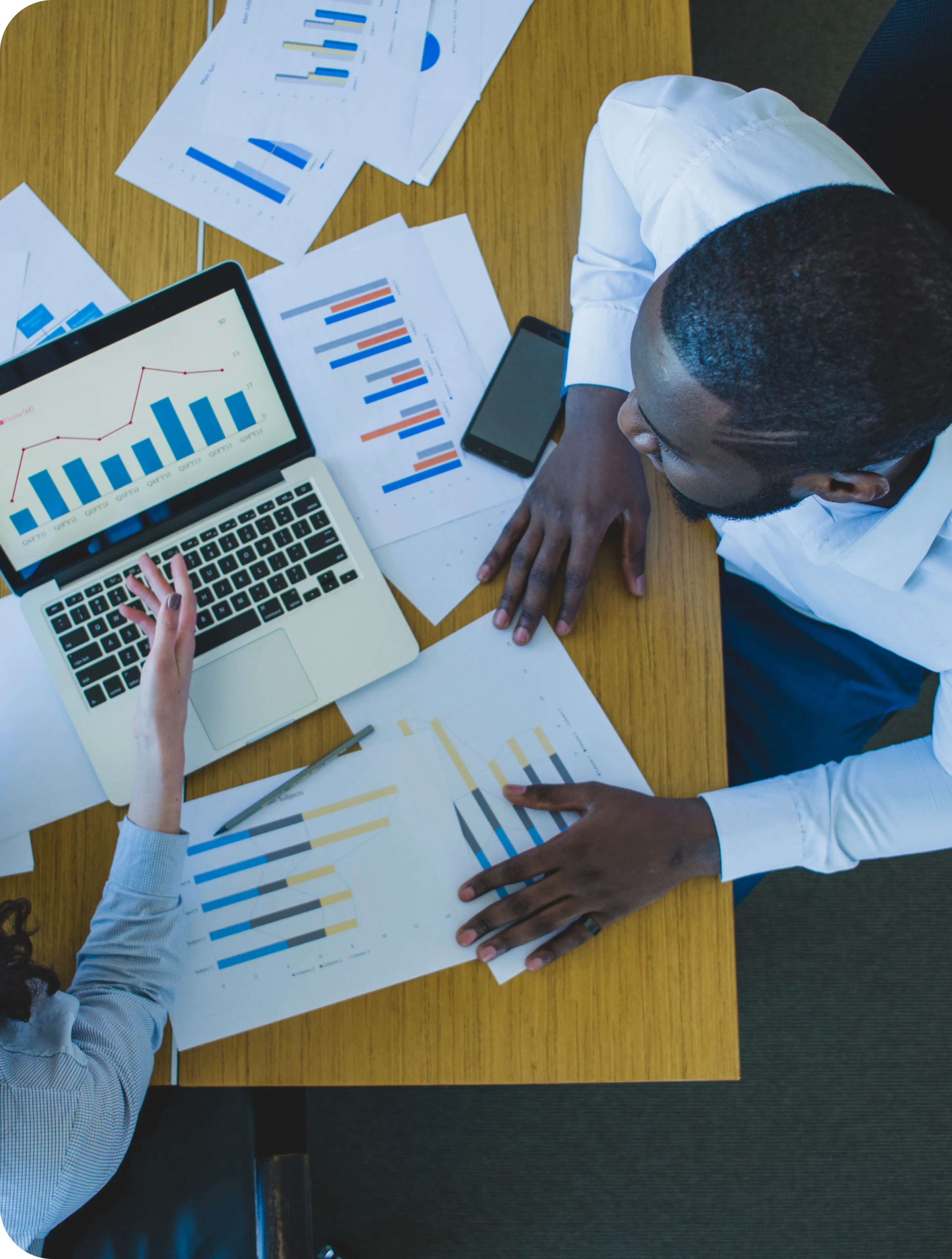 School administrators analyzing financial reports on a laptop